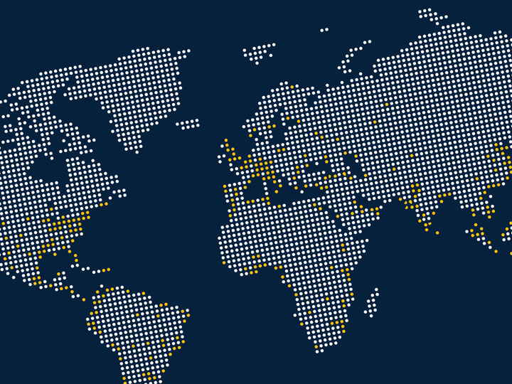 world mapped created with white and yellow dots on a navy blue background